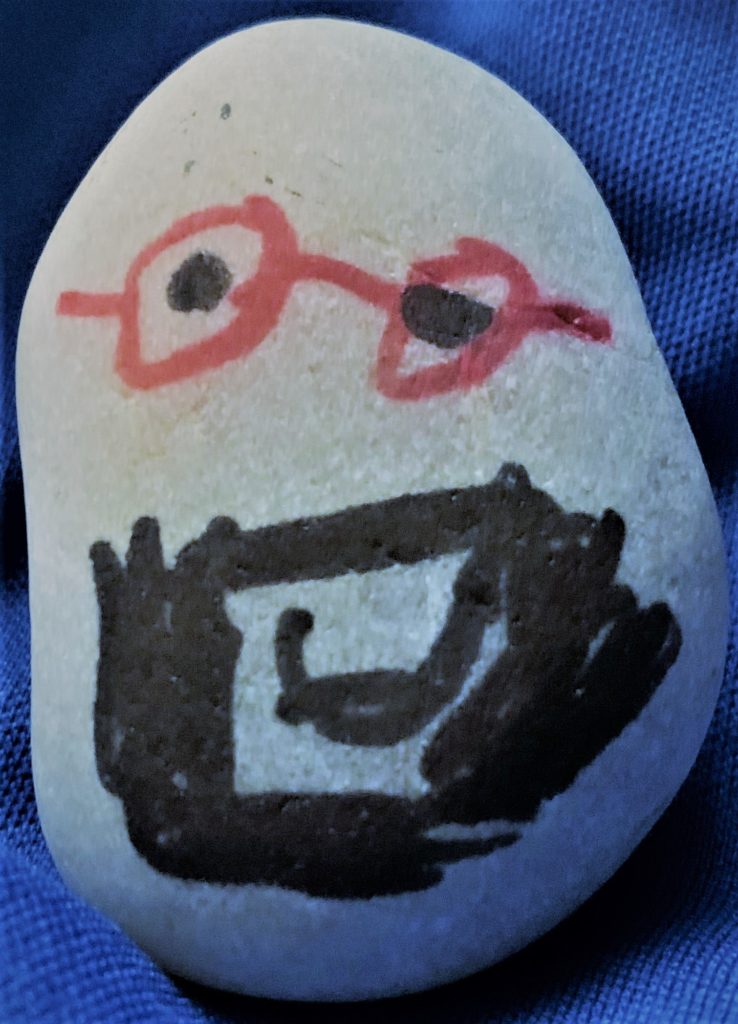 rock painted with a face